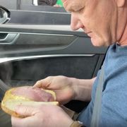 gordon ramsay in a car holding a sandwich