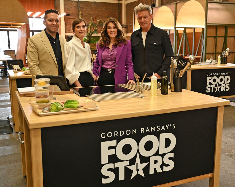 a group of people standing behind a counter with food on it