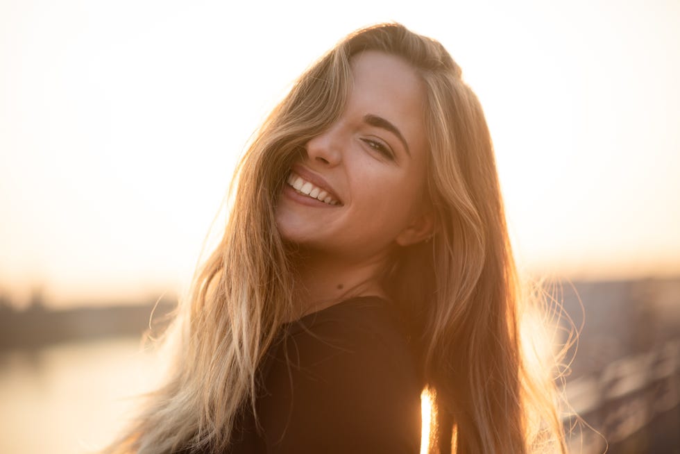 gorgeous teen with long hair posing outside