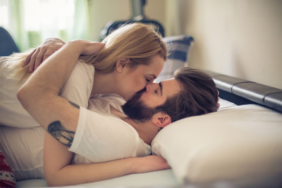 gorgeous young couple kissing in the bed in the morning