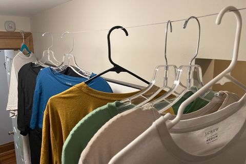 gorillaline retractable clothesline stretched across a room with shirts hanging off of it
