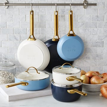 a kitchen counter with greenpa pots and pans