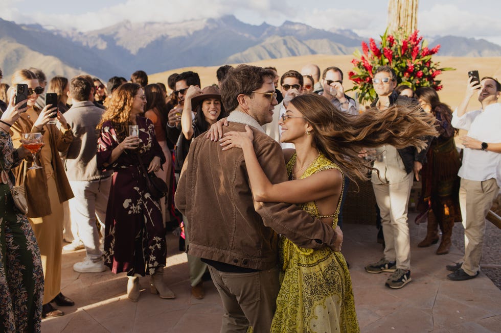 a man and woman dancing in front of a crowd of people