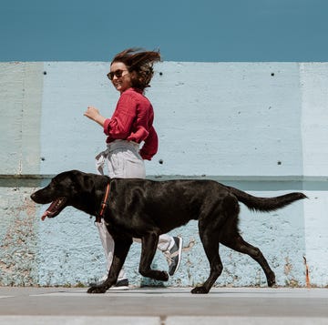 woman running alongside dog