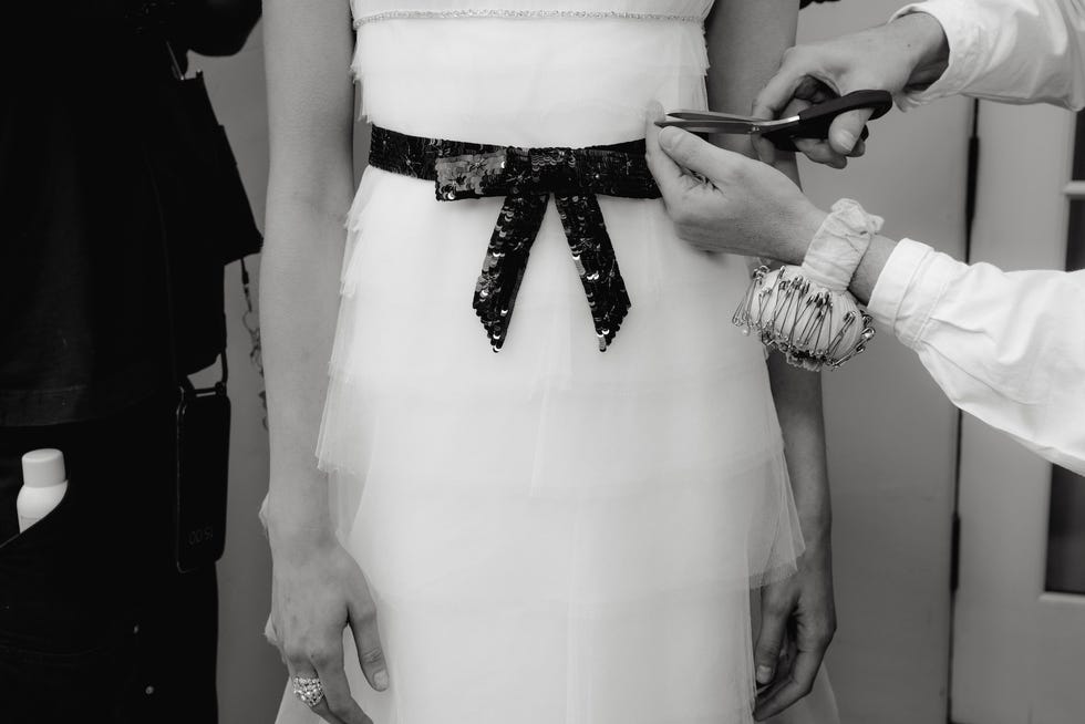 tailoring process with focus on a dresss belt adjustment