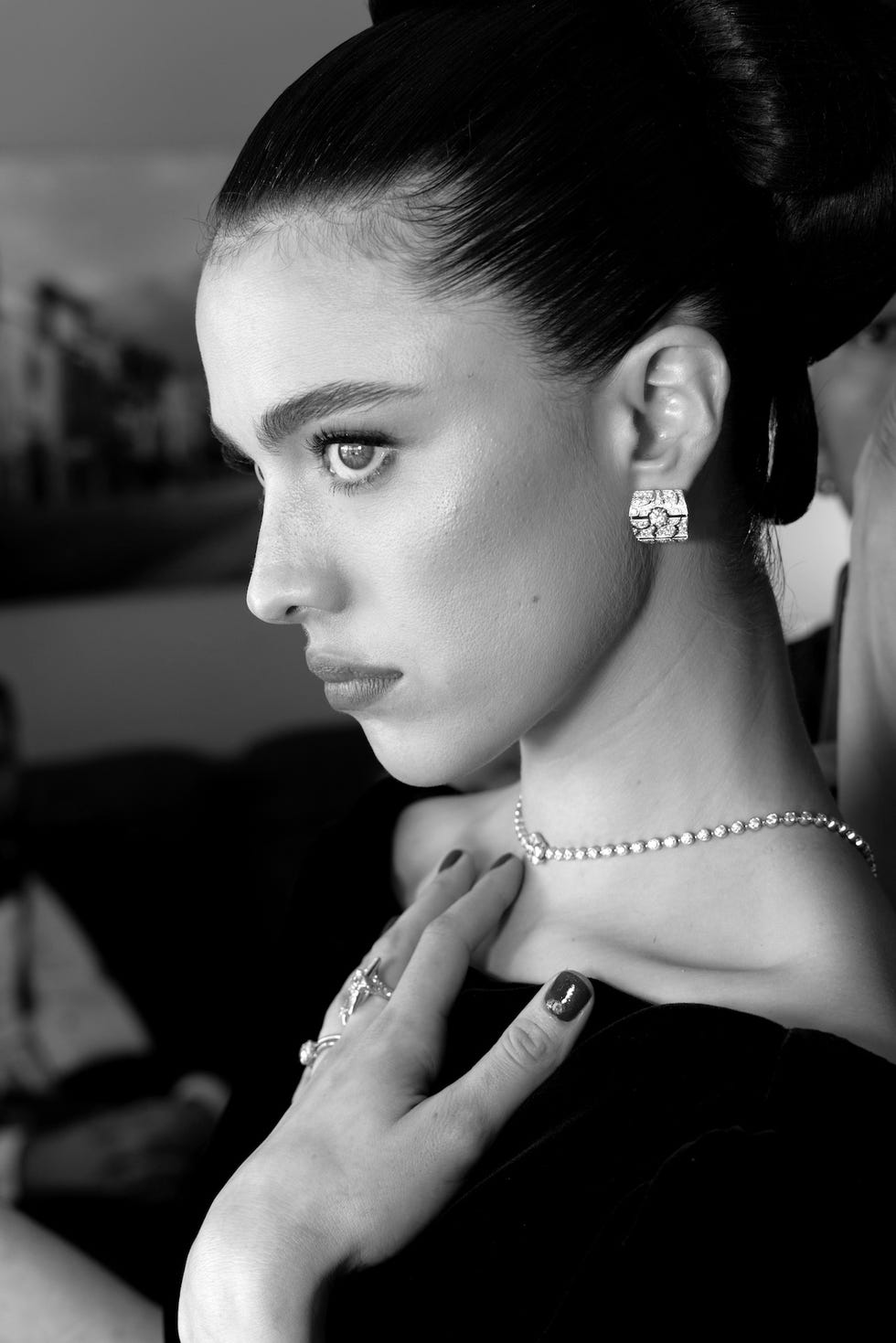 closeup of an elegantly dressed woman showcasing jewelry