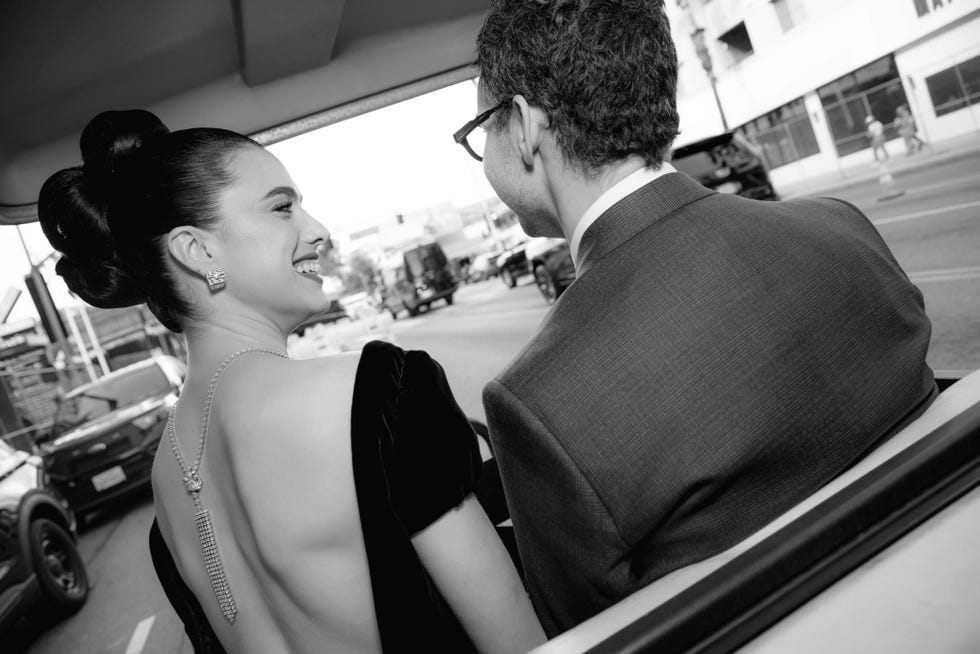 couple in formal attire in a vehicle viewed from behind