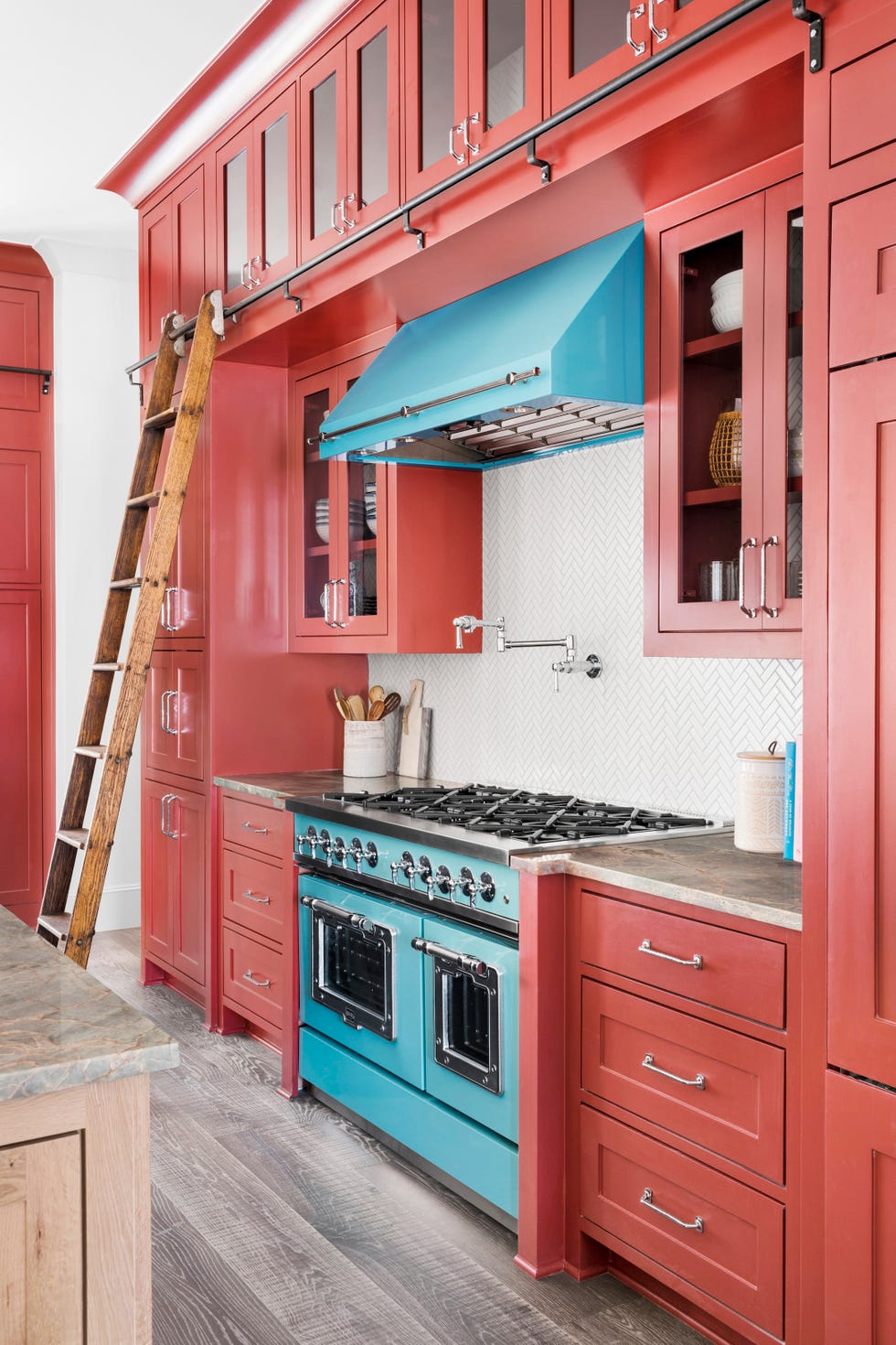 Kitchen with red cabinets and a blue range