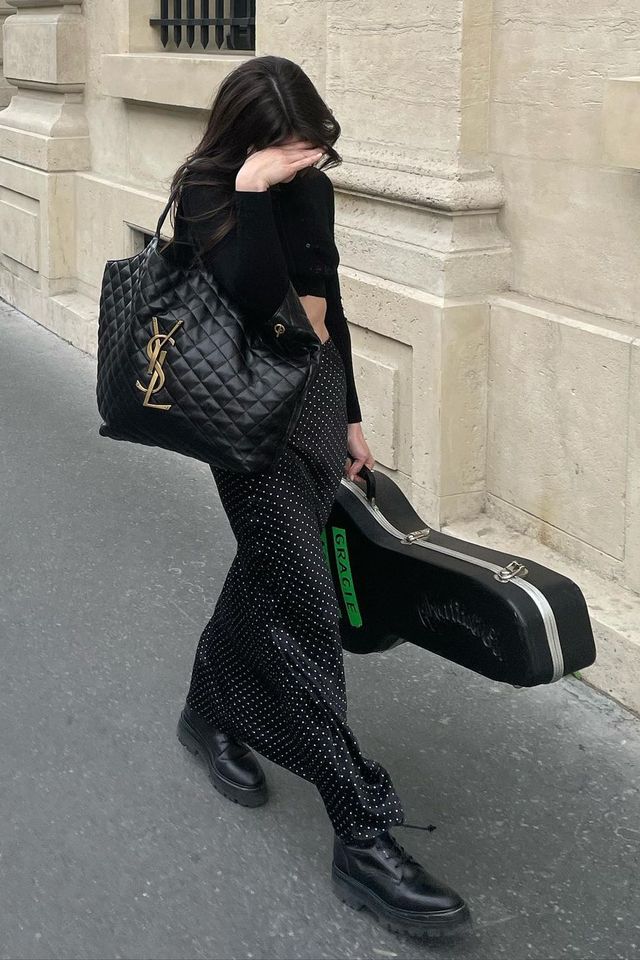 gracie abrams walks with her guitar and a saint laurent shopping bag tote 2022