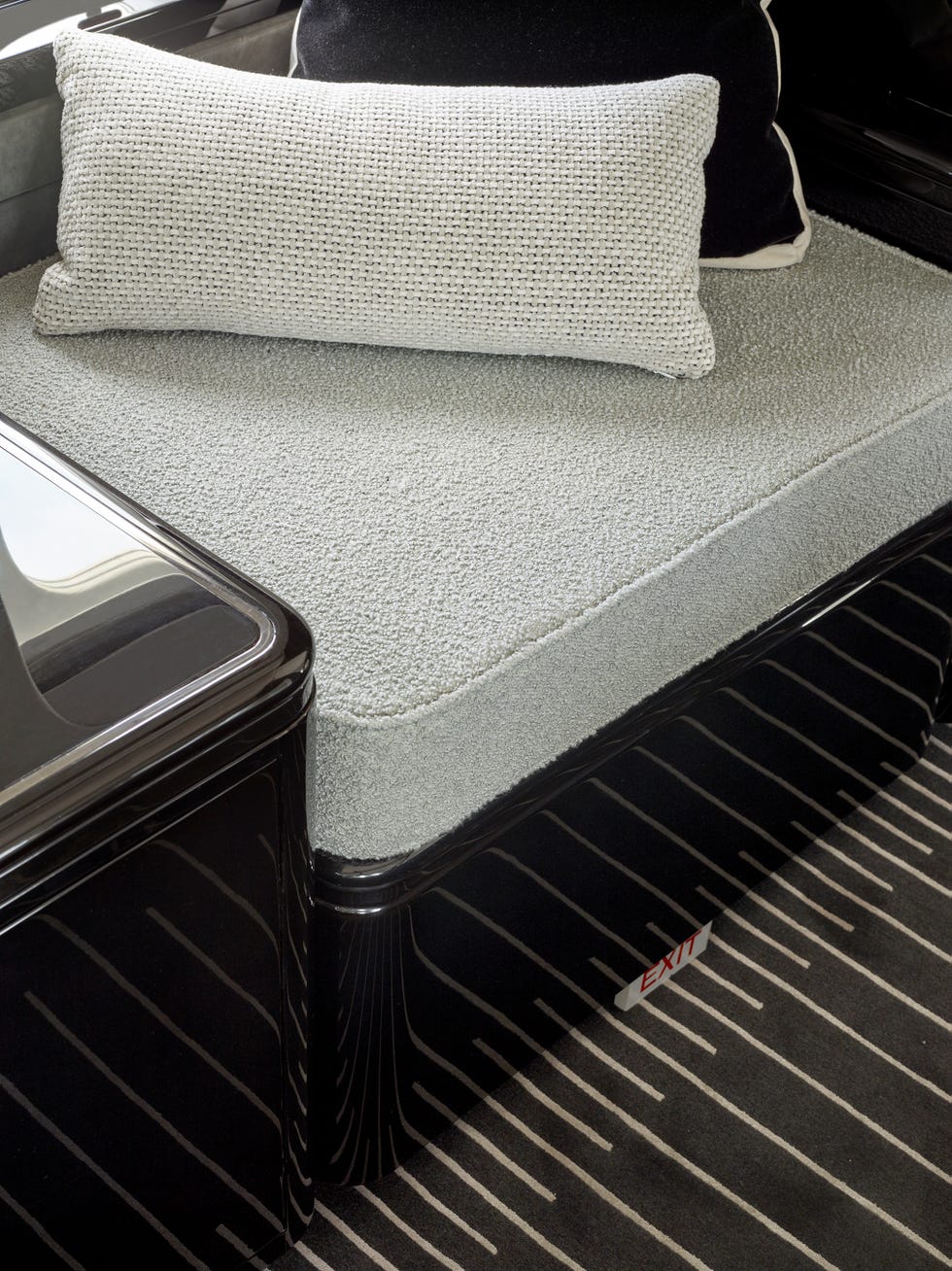 seating area featuring a lightcolored cushion and throw pillows with a modern design