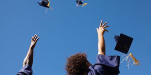 grads throwing their caps in the air