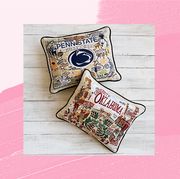 graduation gifts for her including embroidered pillows featuring iconic imagery from one's alma mater and handmade candles featuring scents specific to one's home state