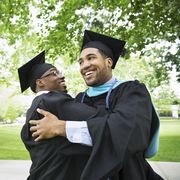 college male graduates hugging and smiling