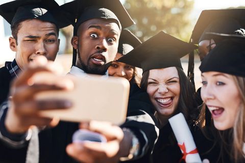 group of friends posing for selfie in graduation outfits
