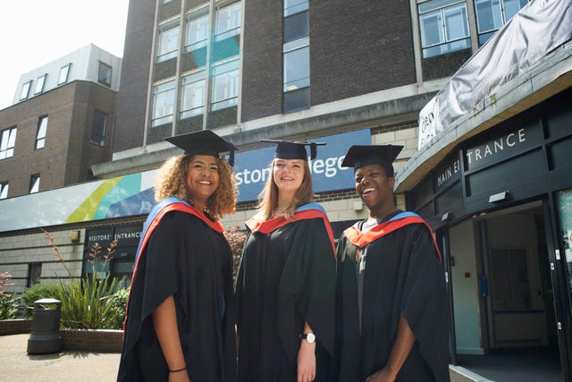 portrait of three college students in graduation gowns and caps