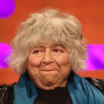 miriam margolyes on the graham norton show, an older woman bites her lip on a chat show