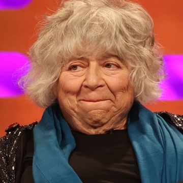 miriam margolyes on the graham norton show, an older woman bites her lip on a chat show