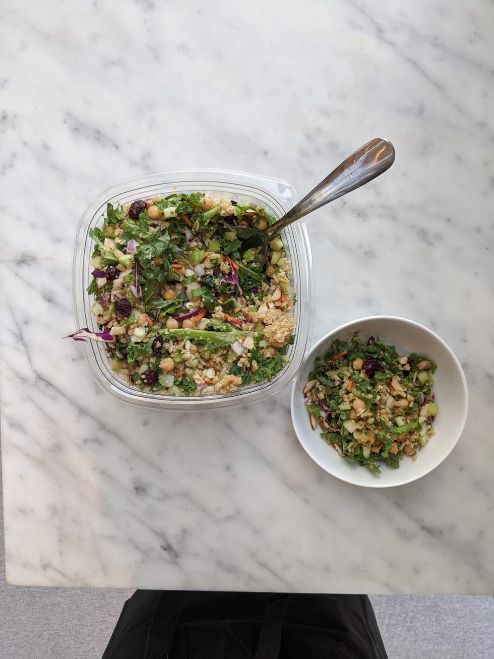 best costco prepared meals kirkland signature grain & celery salad with apple cider vinaigrette in a plastic container with a bowl alongside