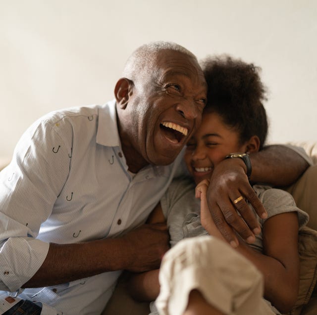 grandfather playing with her granddaughter at home