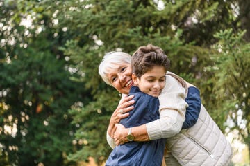 grandmother and her cute little grandson are having fun in nature