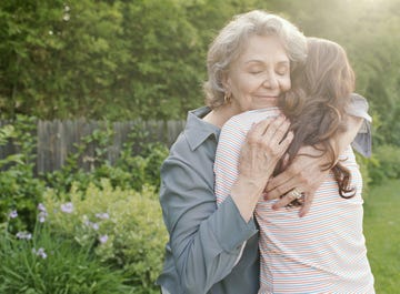 Grandmother embracing adult granddaughter