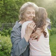 Grandmother embracing adult granddaughter