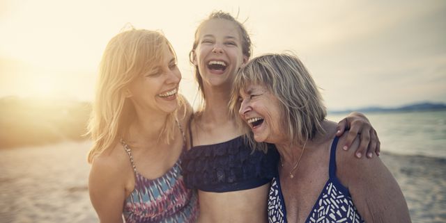 Grandmother, mother and daughter enjoying time together on a beach