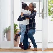 front view of grandmother hugging her granddaughter authentic senior retired life concept