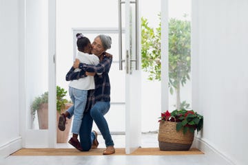 front view of grandmother hugging her granddaughter authentic senior retired life concept