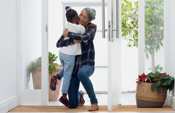 front view of grandmother hugging her granddaughter authentic senior retired life concept