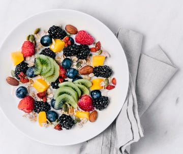 Granola with milk and a variety of fresh and dried fruits