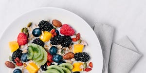 Granola with milk and a variety of fresh and dried fruits