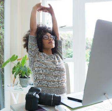 Graphic designer stretching her arms