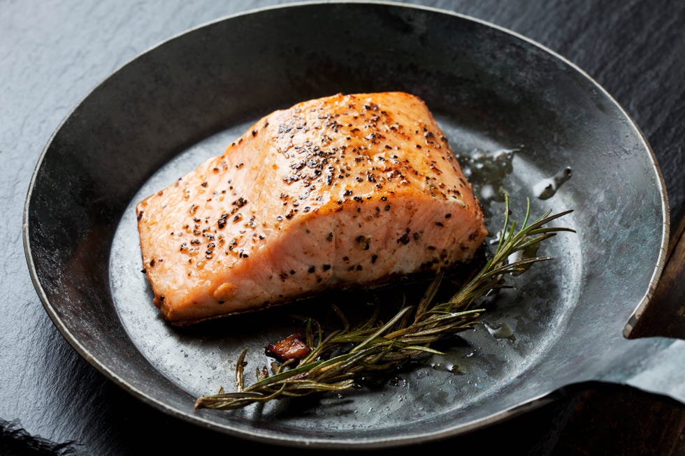 Fried salmon fillet in a frying pan