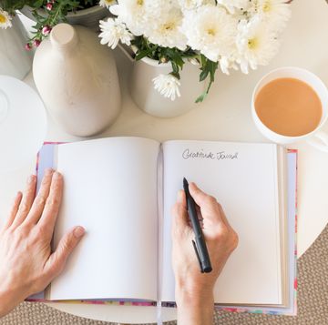Woman's hands with gratitude journal
