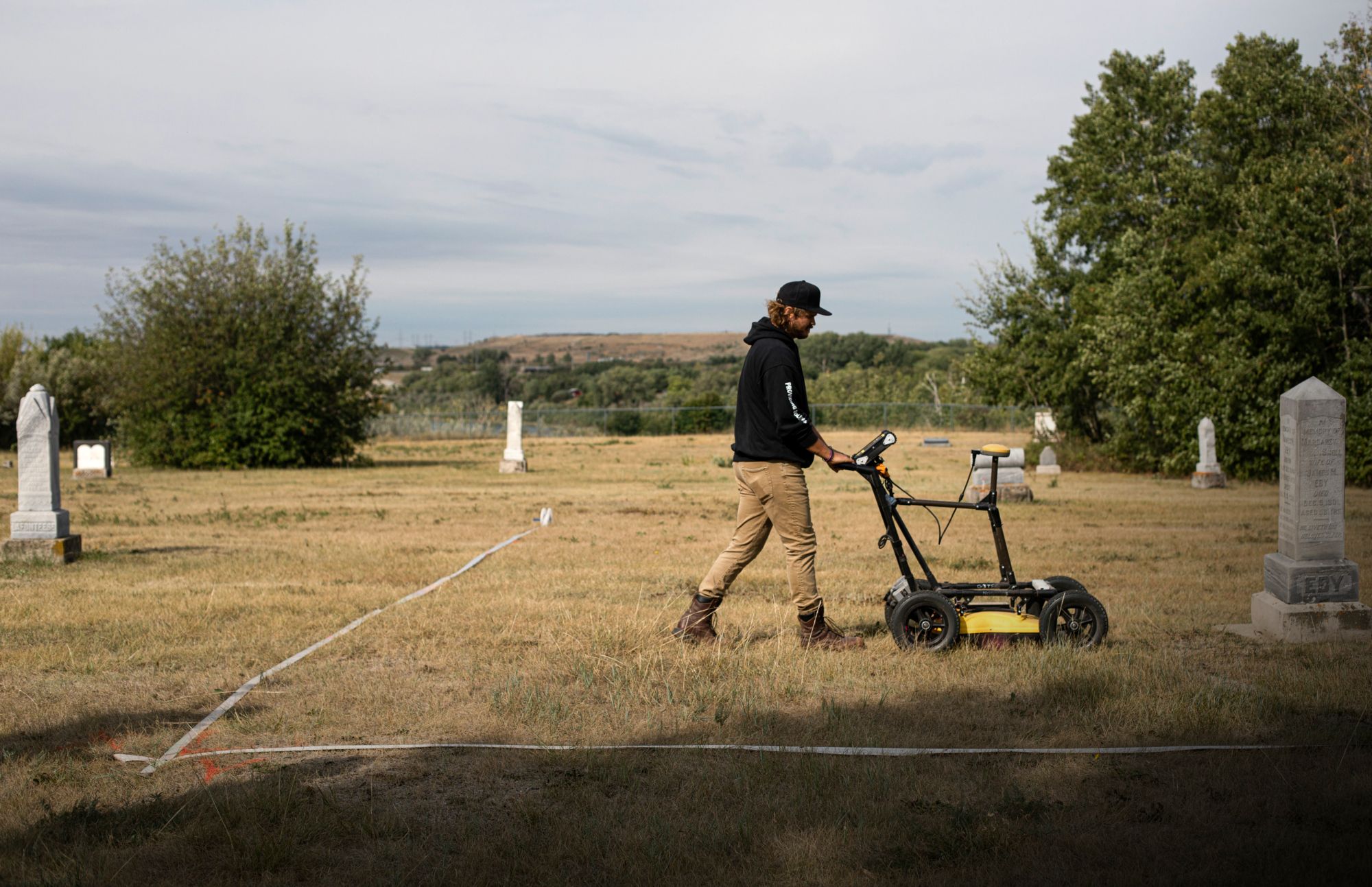jordan swenson demonstrates how he collects data with ground penetrating radar, at nutana cemetery, a historical burial ground dating back to 1884, in saskatoon, saskatchewan monday, august 23, 2021 the technology has been behind many of the discoveries of unmarked graves at former indian residential schools, but reliably identifying graves requires direction from both oral histories, and a careful interpretation of data