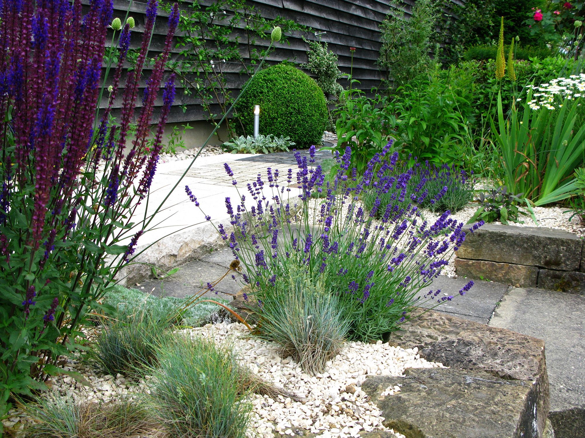 What mulch color/ variety should I replace the current mulch with to make  it look better? We have decorative stones on the border shown here and all  around our home . : r/landscaping