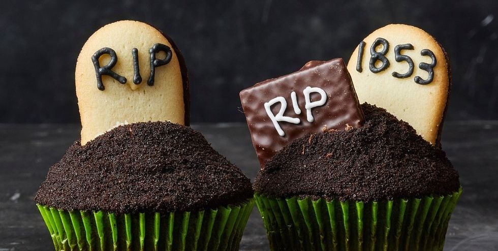 chocolate cupcakes with graveyard cookies decorated on top
