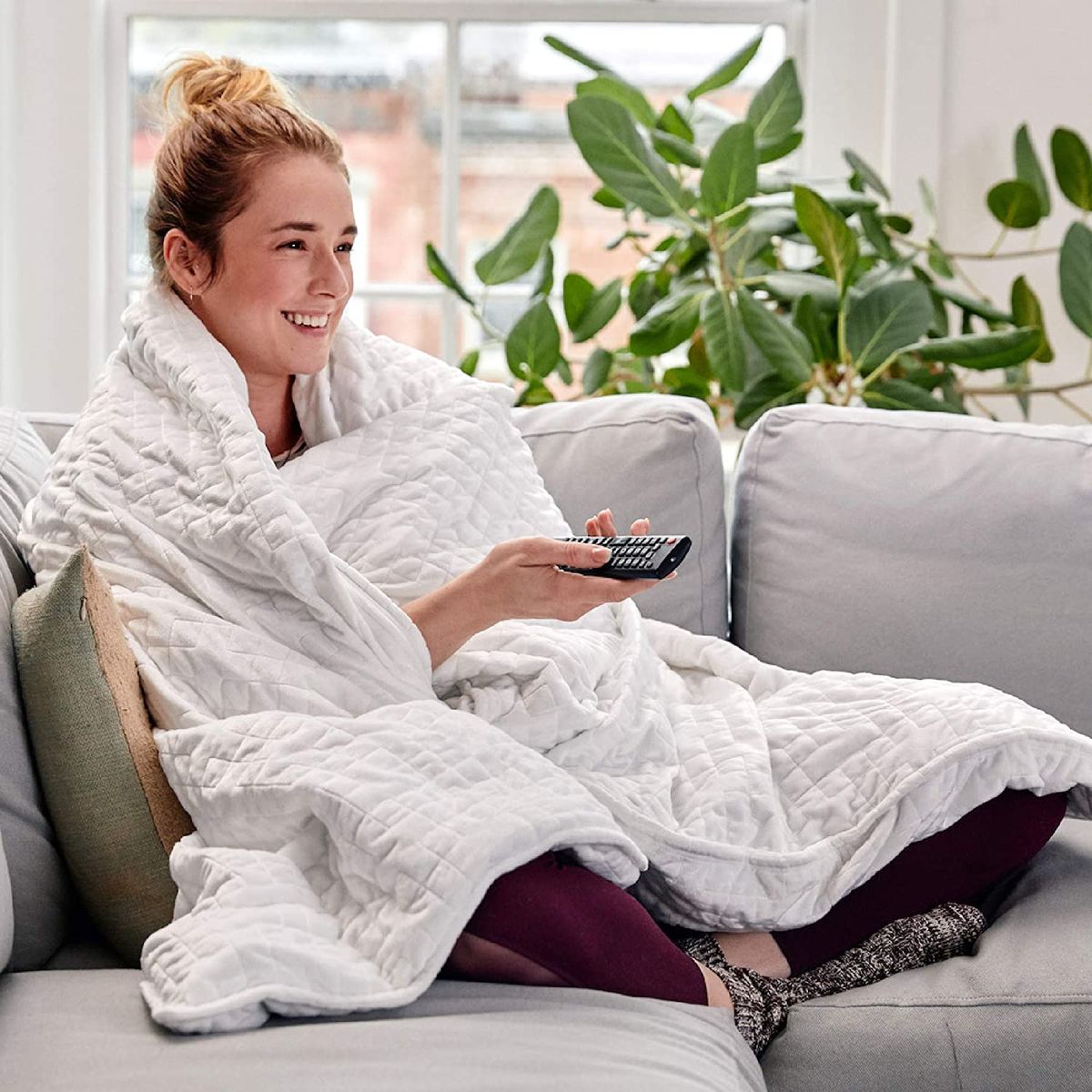 woman wrapped in gravity weighted blanket