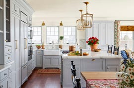 airy coastal kitchen with cabinets and island painted in silver lining by benjamin moore