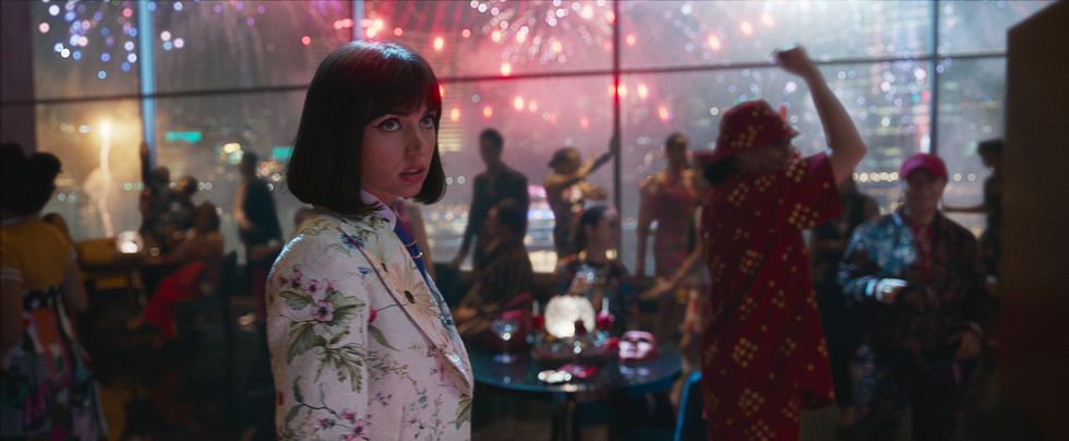 ana de armas as dani miranda, stands in a busy club in a scene from netflix movie the gray man