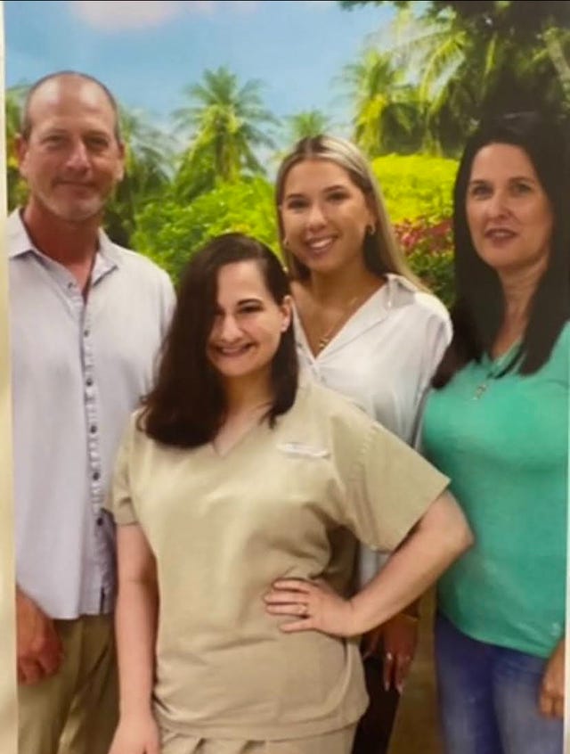 a group of people posing for a photo and smiling