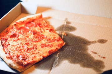 greasy pizza in a delivery box