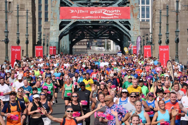 a crowd of runners taking part in the great north run