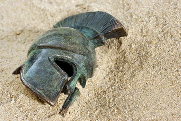 a metal helmet in sand