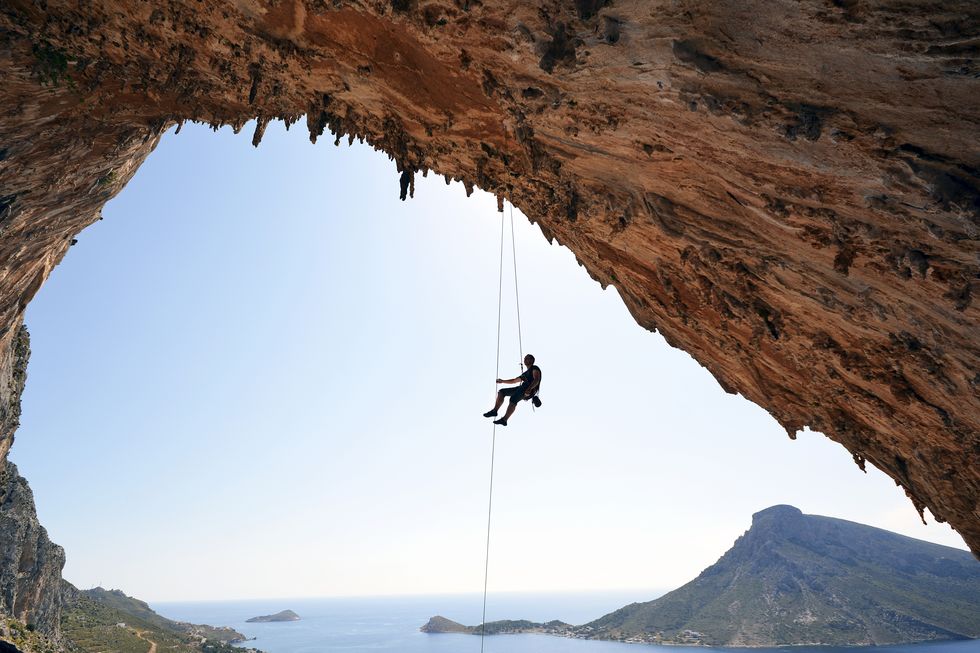 Greece, Kalymnos, climber abseiling in grotto