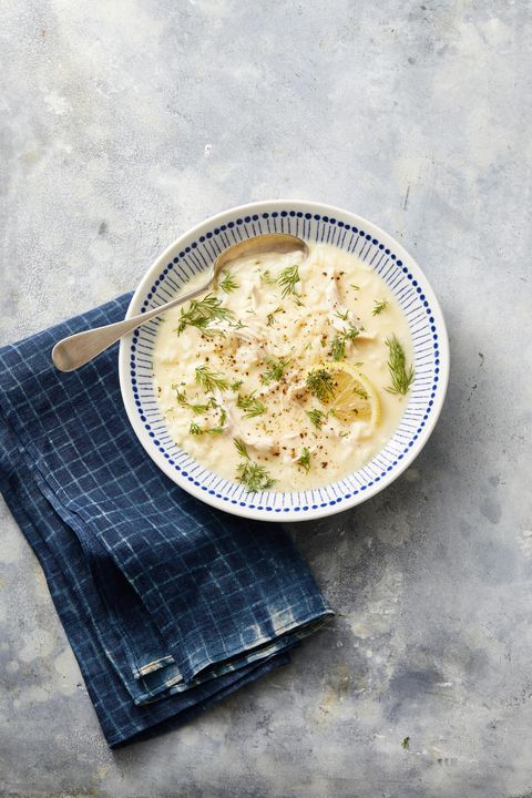 greek lemon chicken soup in a blue and white bowl
