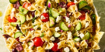 bowtie pasta tossed with cherry tomatoes, cucumbers, feta, and olives