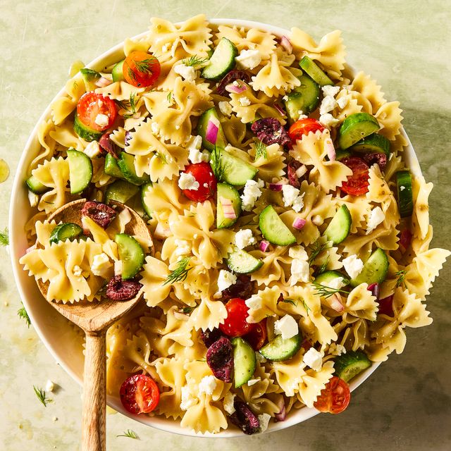bowtie pasta tossed with cherry tomatoes, cucumbers, feta, and olives