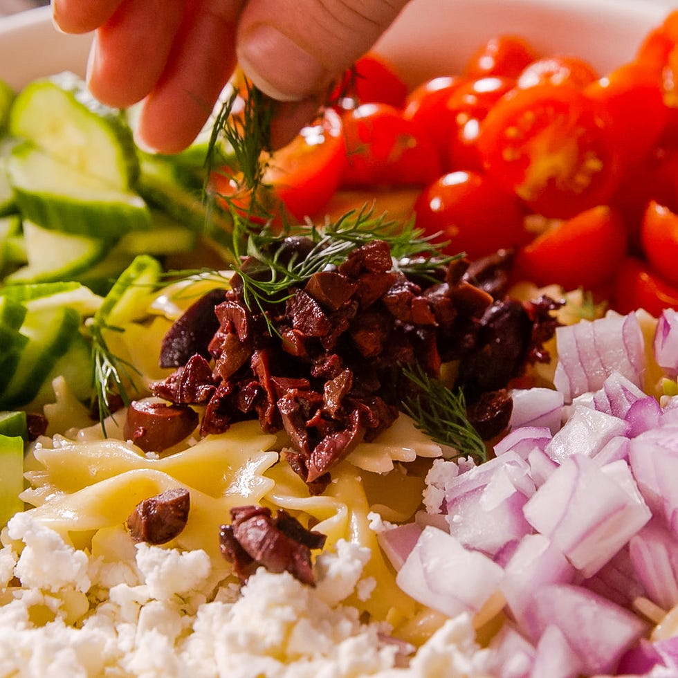 bowtie pasta tossed with tomatoes, cucumber, feta, red onion, and olives